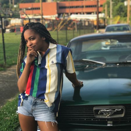 Imani Duckett posed for a picture in front of a Ferrari.